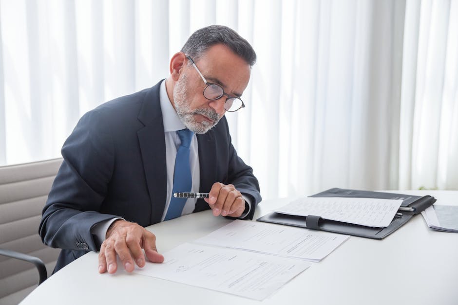 Note buyer reviewing a business note document at a desk